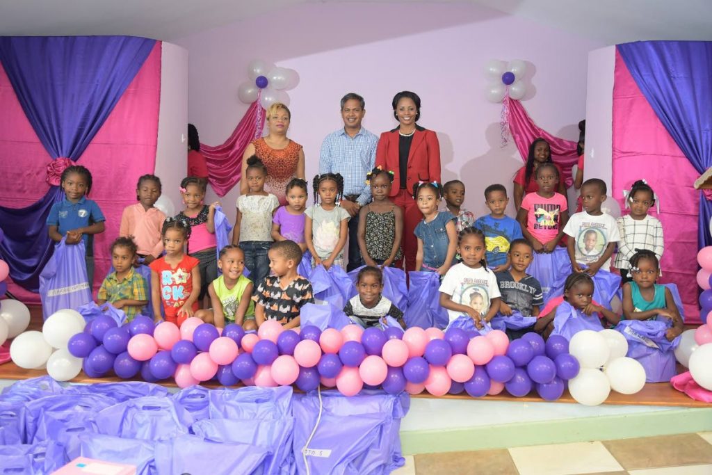 Anil Seunath, centre, back row) and West Indies/TTl cricketer and Atlantic Sports Ambassador Merissa Aguilleira with some of the children who received school supplies in the Merissa Aguilleira Back to School Programme.