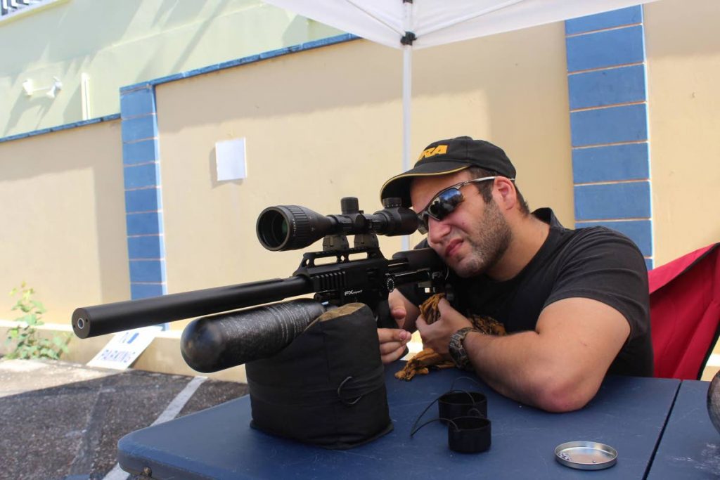 Coordinator and founder of the Blue Line Law Enforcement Academy Paul Nahous takes aim with his FX Impact Air Rifle at the Academy's grounds on Woodford Street, Port od Spain at a fundraiser on Sunday.