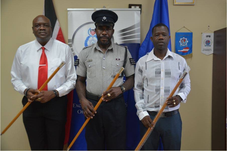 From left, Sgts Dexter Miller, Andell Alleyne and Ray Mitchell posed for a photo after being promoted at a ceremomy at ACP Garfield Moore’s office at the Scarborough Police station.