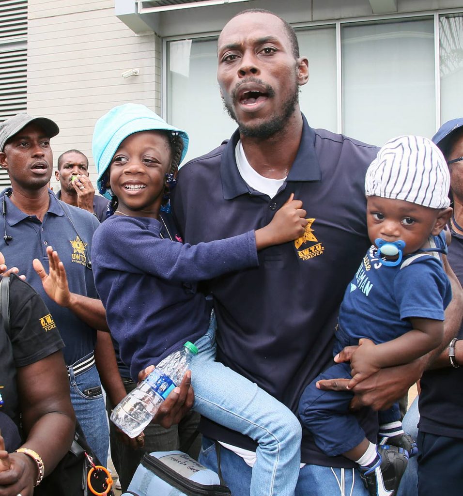 Support for Daddy: OWTU member Daniel George got full support from his children, Makeda and Micah, as union members led by president Ancel Roget gathered outside the Office of the Prime Minister, St Clair. PHOTO BY AZLAN MOHAMMED