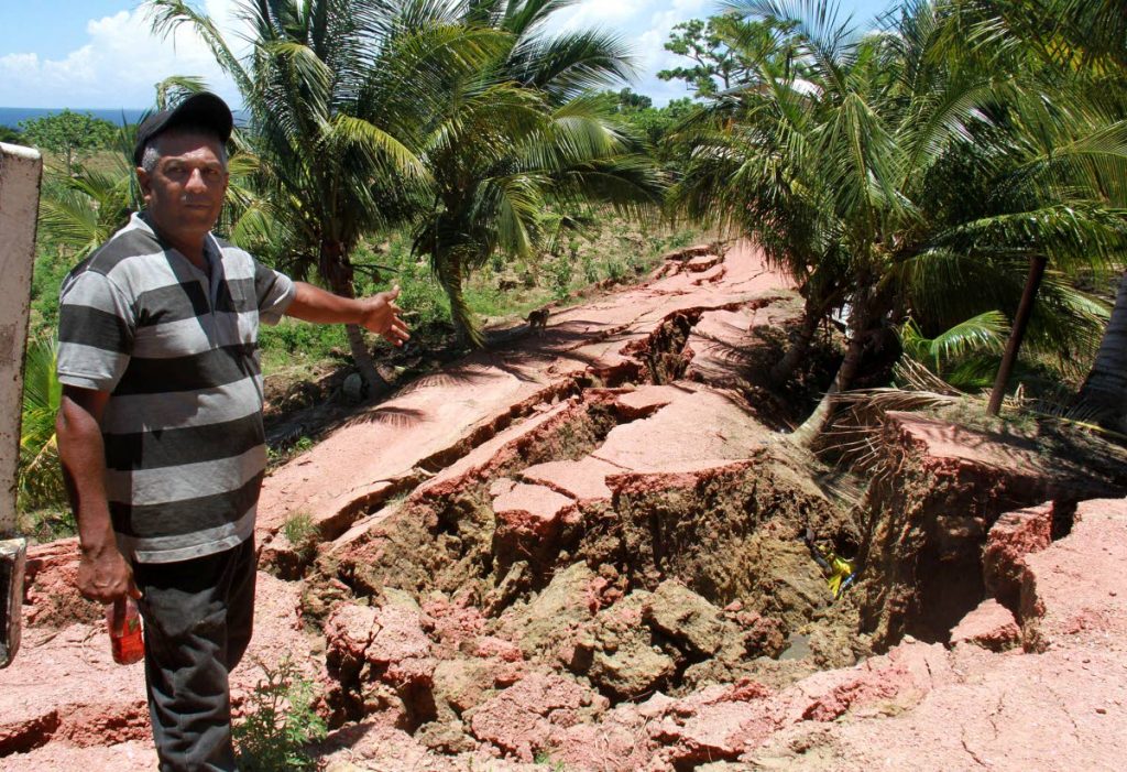 Earth moves:Nobbie Mathura points to huge cracks on Los Iros Hillview Road
after last
Tuesday’s 6.9 earthquake.FILE PHOTO/ANIL RAMPERSAD