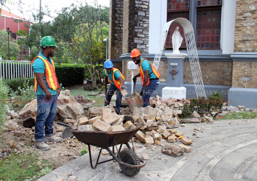 Workmen removing rubble ouside the Holy Trinity Cathedral, Port of Spain  after Tuesday’s earthquake damage portion of the church.