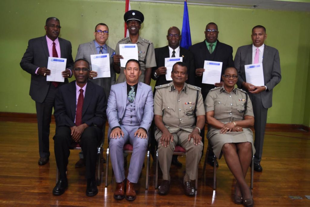 In the front row, Police Commissioner Gary Griffith is flanked, from left, by DCP (Ag) Crime and Support, Harold Phillip, DCP (Ag) Operations Deodat Dulalchan and DCP (Ag) Administration, Erla Christopher at the promotion ceremony for seven assistant commissioners of police at Solomon McLeod Lecture Theatre, Police Administration Building, Port of Spain on Friday. 
The officers (left to right) are ACP Leroy Brebnor, ACP Irwin Hackshaw, ACP Garfield Moore, ACP Vincel Edwards, ACP Ansley Garrick and ACP Harrikrishen Baldeo. Missing is ACP Sharon Blake-Clarke. PHOTO COURTESY TTPS