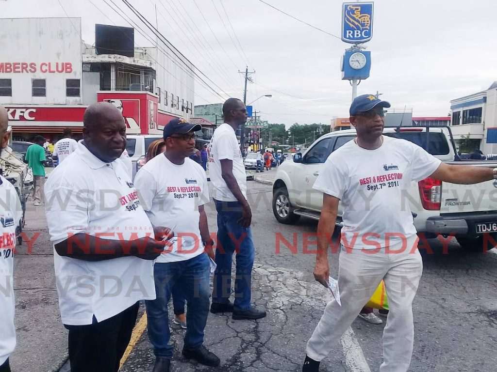 Join us: OWTU president general Ancel Roget and his team hands out flies in Point Fortin last Friday, calling on the public to take part in the day of rest and reflection on September 7. PHOTO BY SEETA PERSAD
