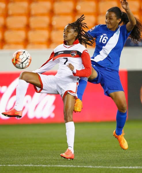 TT midfielder Kayla Taylor, left, scored a hat-trick against Cuba yesterday in the CONCACAF Caribbean final round of qualification in Jamaica. 