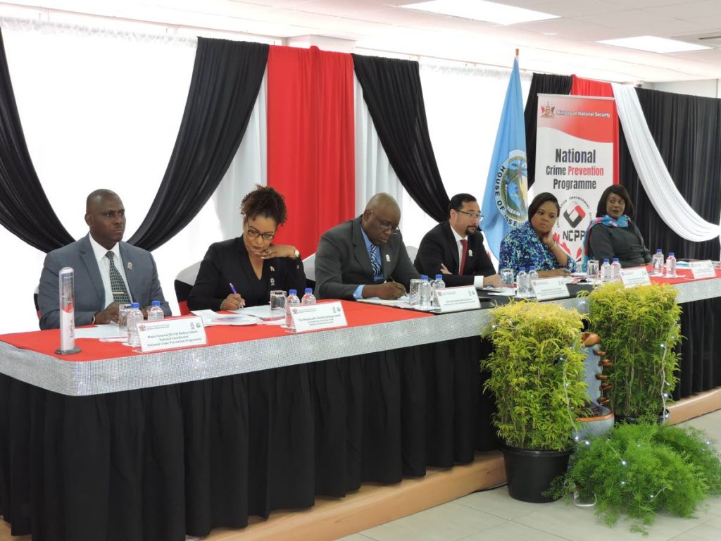 Minister of National Security Stuart Young, fourth from left, sits with, from left, National Coordinator of the National Crime Prevention Programme (NCPP) , retired  Major General Rodney Smart, Parliamentary Secretary Glenda Jennings-Smith, THA Chief Secretary Kelvin Charles, MP for Tobago West Shamfa Cudjoe and Manager of the NCPP Secretariat Cheryl St Louis Felix,   at last Friday launch of the programme at the Conference Room of the Division of Community Development on Glen Road.