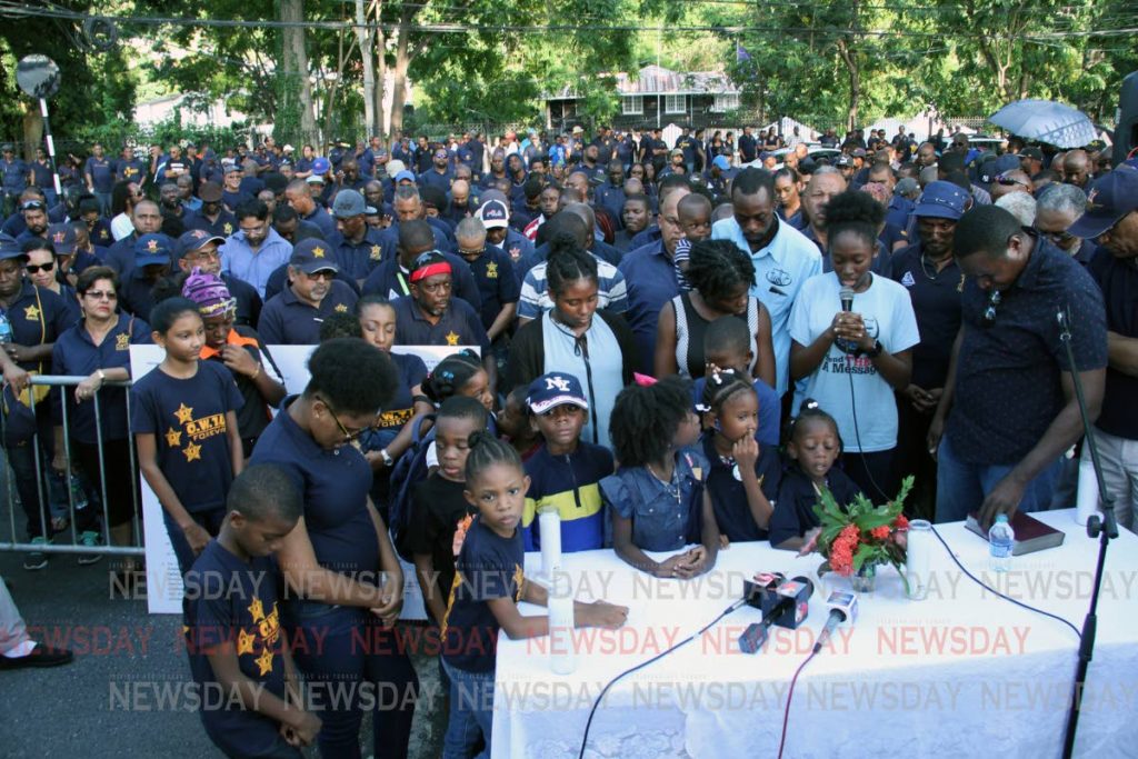 BLESS THE PM: Children praying yesterday during the OWTU’s evening of prayers. PHOTO BY SUREASH CHOLAI