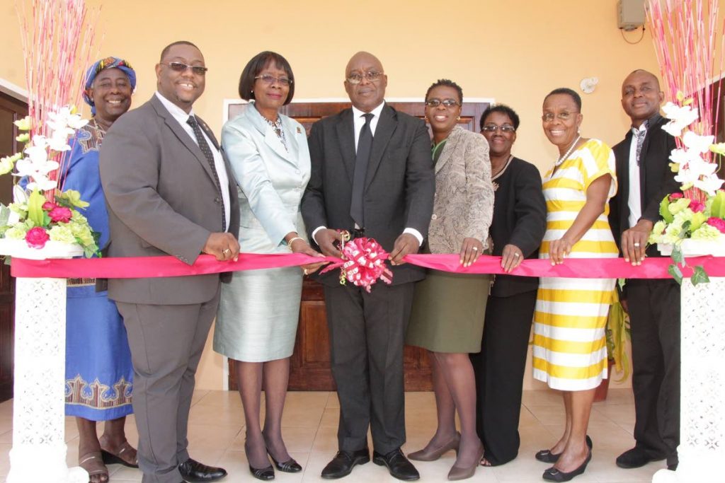 Chief Secretary Kelvin Charles, centre, cuts the ribbon to open Tobago’s first Community Residence for Children last week Thursday. Others in photo are from left, Dawn George, board member, and Hanif Benjamin, Chairman of the Children’s Authority, Health Secretary Dr Agatha Carrington, Dianne Baker-Henry, Administrator, Division of Health, Hazel Thompson-Ahye, Deputy Chairman -  Chidren’s Authority,  Dr Maria Dillon -Remy, Chairman, Facilities Review Committee (Homes for Children) and Bishop Robinson C Alleyne of the Healing Tabernacle Ministries.