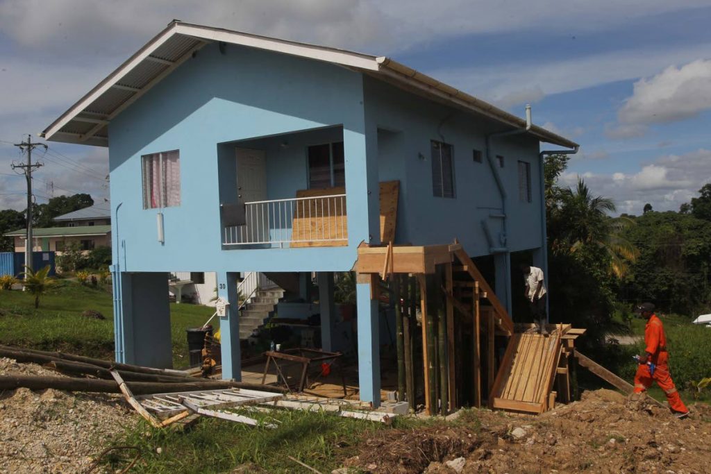 A stairway is under repair, on Monday, at one of the houses at the HDC development Mora Heights in Rio Claro which was damaged during last Tuesday's 6.9 earthquake. PHOTO BY LINCOLN HOLDER
