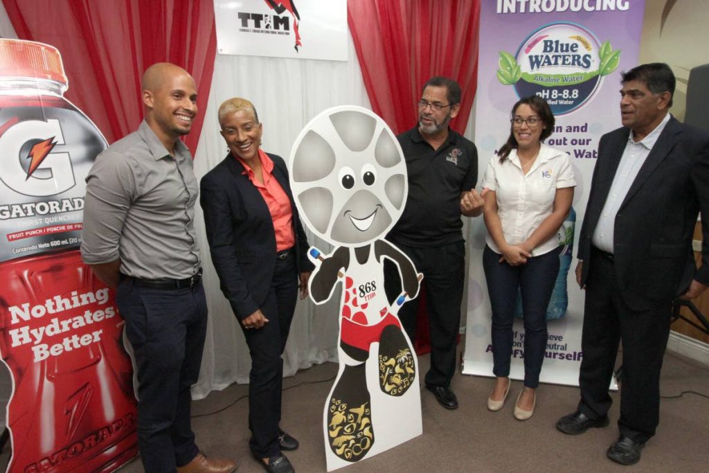 Diane Henderson,left, chairperson of the TT International Marathon Festival and Francis Williams-Smith TTIM race director, centre, are flanked by Gatorade brand manger Joel Dalrymple, left, and Sarah Jones, Bermudez research and communication manager, second from right, and Anthony Harford, director of All Sports Promotions, yesterday at the launch of the TTIM Festival 2019. PHOTO BY ROGER JACOB