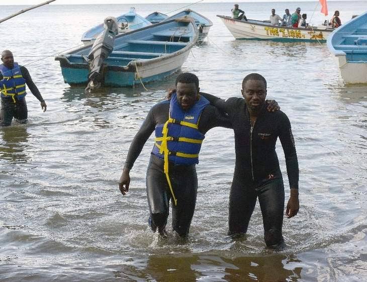 Minority Council Leader Watson Duke, and member Farley Augustine during their protest swim from Scarborough to Toco on August 28 last year to highlight problems with transportation on the sea bridge.