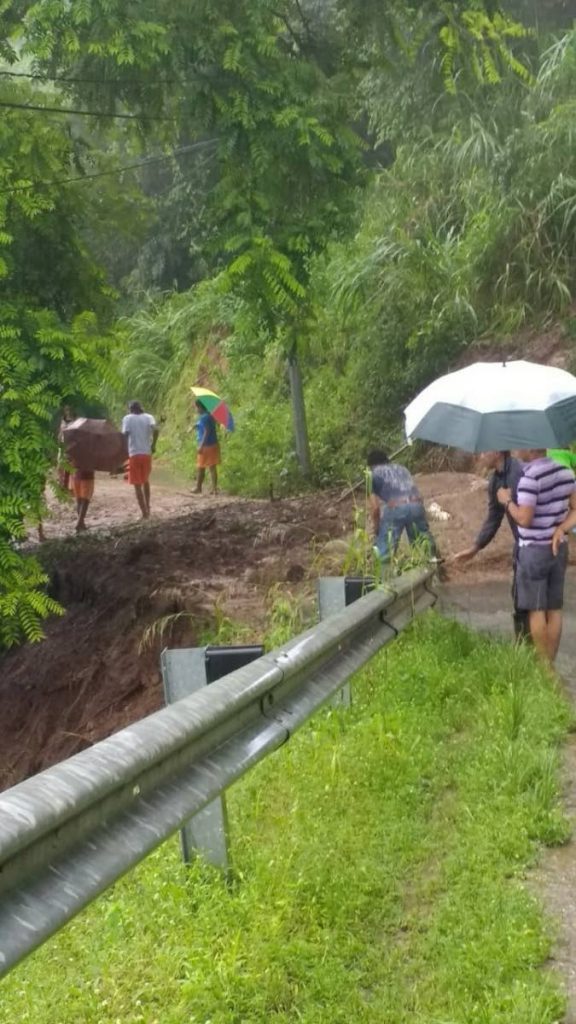 File photo: Residents of Morne Espoire, Paramin, assess damages to the only access road after heavy rains last July.