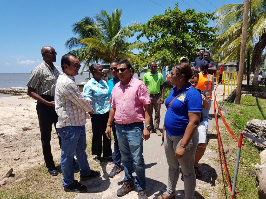 Flashback: In this August 18 file photo, Cedros councillor Shankar Teelucksingh, left, talks with Works Minister Rohan Sinanan at the flood gates in Bonasse Village Cedros during a tour of projects in Point Fortin and La Brea. Teelucksingh yesterday called on the Health Ministry to give details of its findings that malaria tests done on 50 people were negative. FILE PHOTO
