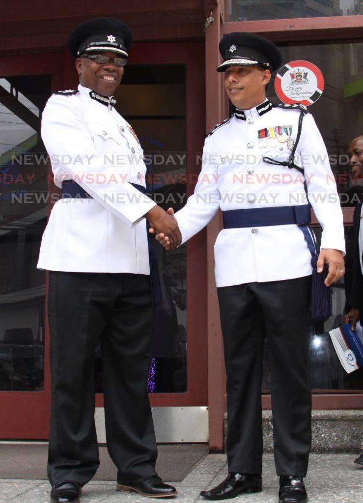 In service together: Police Commissioner Gary Griffith greets Deputy Police Commissioner Stephen Williams at the Police Administration Building, Port of Spain for the Independence Day toast to TT yesterday. Williams acted as police commssioner for six years and was not confirmed in the post by Parliament which chose Griffith to lead the police service. PHOTO BY ANGELO MARCELLE