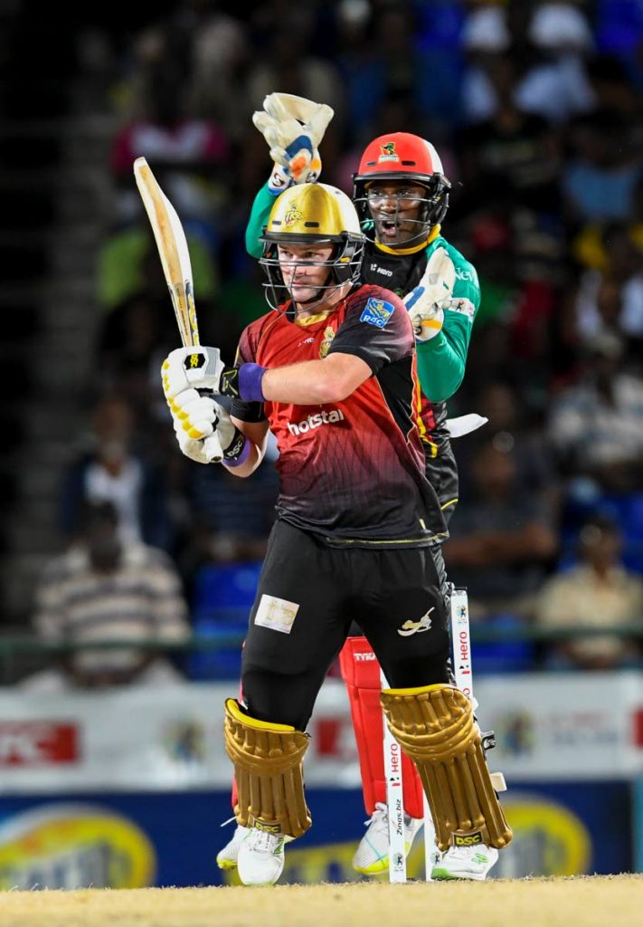 Devon Thomas (R) of St Kitts & Nevis Patriots jump as Colin Munro (L) of Trinbago Knight Riders hits 4 during match 23 of the Hero Caribbean Premier League between St Kitts & Nevis Patriots and Trinbago Knight Riders at the Warner Park Sporting Complex yesterday in Basseterre, St Kitts, Saint Kitts And Nevis. 