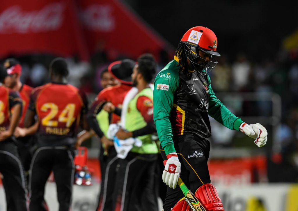 Chris Gayle (R) of St Kitts & Nevis Patriots walks off the field during match 23 of the Hero Caribbean Premier League between St Kitts & Nevis Patriots and Trinbago Knight Riders at the Warner Park Sporting Complex yesterday in Basseterre, St Kitts.