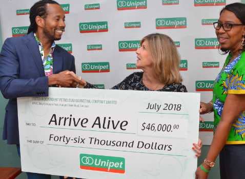 Chief operating officer of Unipet Kirt Hills presents a cheque to Sharon Inglefield of Arrive Alive  and Cynthia Henry.