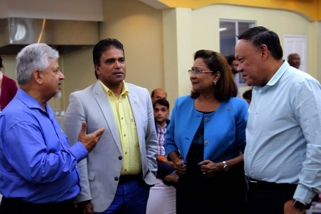 TALK SHOP: Opposition Leader Kamla Persad-Bissessar speaks with MPs Dr Bhoendradatt Tewarie, Dr Roodal Moonilal and David Lee after a press conference at the Passage to Asia restaurant in Chaguanas yesterday.