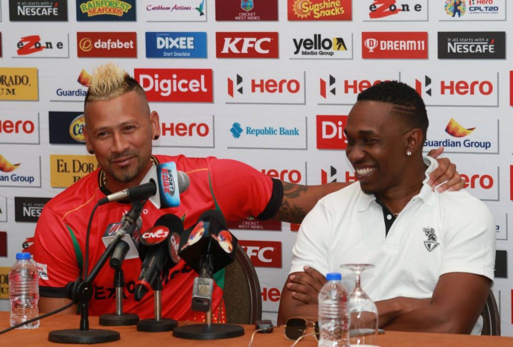 Guyana Amazon Warriors captain Rayad Emrit (left) and Trinbago Knight Riders captain Dwayne Bravo share a light moment during a Hero CPL press conference at the Hyatt Regency Hotel, Port of Spain recently.