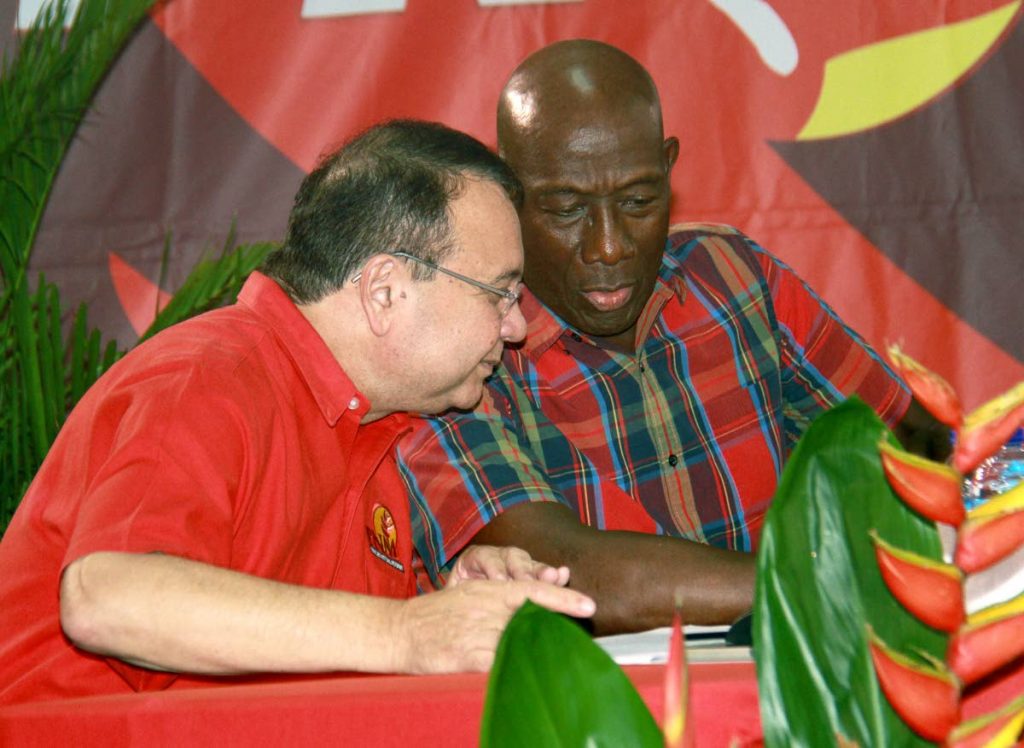 SERIOUS BUSINESS: Minister of Energy and Energy Affairs, Franklin  Khan and Prime MInister Dr Keith Rowley at a public meeting held at the Marabella Community facility.