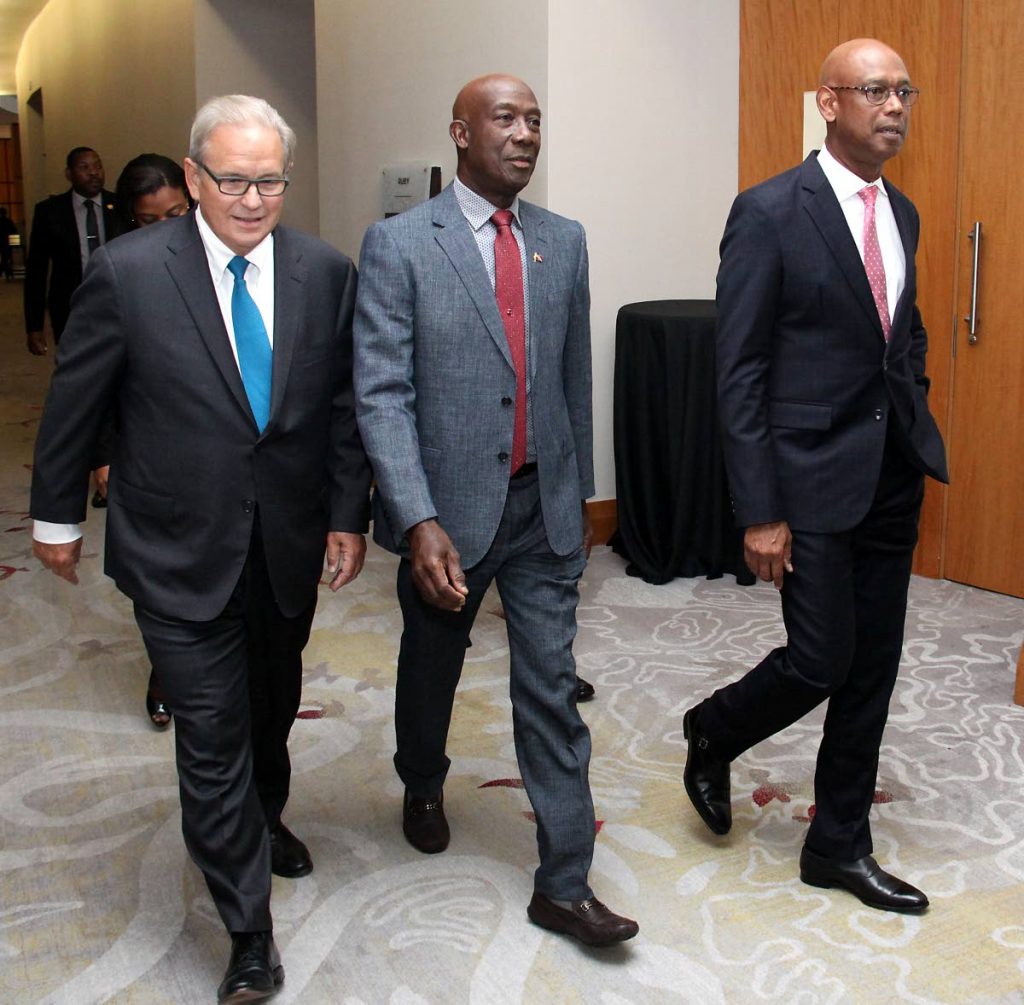 Prime Minister Dr Keith Rowley flanked by Royal Dutch Shell Non-Executive Chairman, Charles O Holliday, left, and Vice President, Shell Trinidad and Tobago, Derek Hudson at the Shell Energy luncheon, Hyatt, Port of Spain.