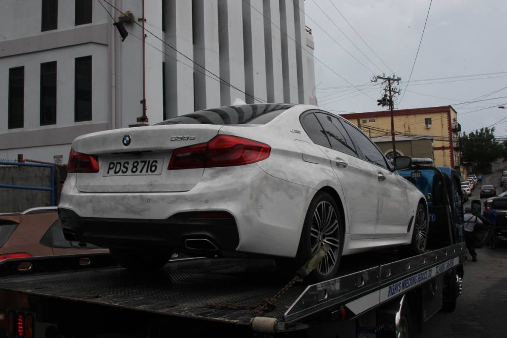 CRIME EXHIBIT: Natalie Pollonais’ car is taken to the Police Administration Building in San Fernando yesterday.