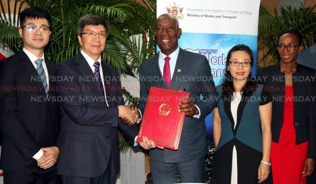 Prime Minister Dr. Keith Rowley was seen shaking hands with Chinese Ambassador Song Yumin as he held the signed agreement between NIDCO and the China Harbour Engineering Company (CHEC) to build a Dry Docking Facility in La Brea. PHOTO BY ANSEL JEBODH