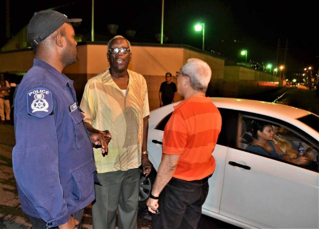 WRECKING TALK: Commodore Franklin, centre, and another driver speaking with a police officer about the wrecker.