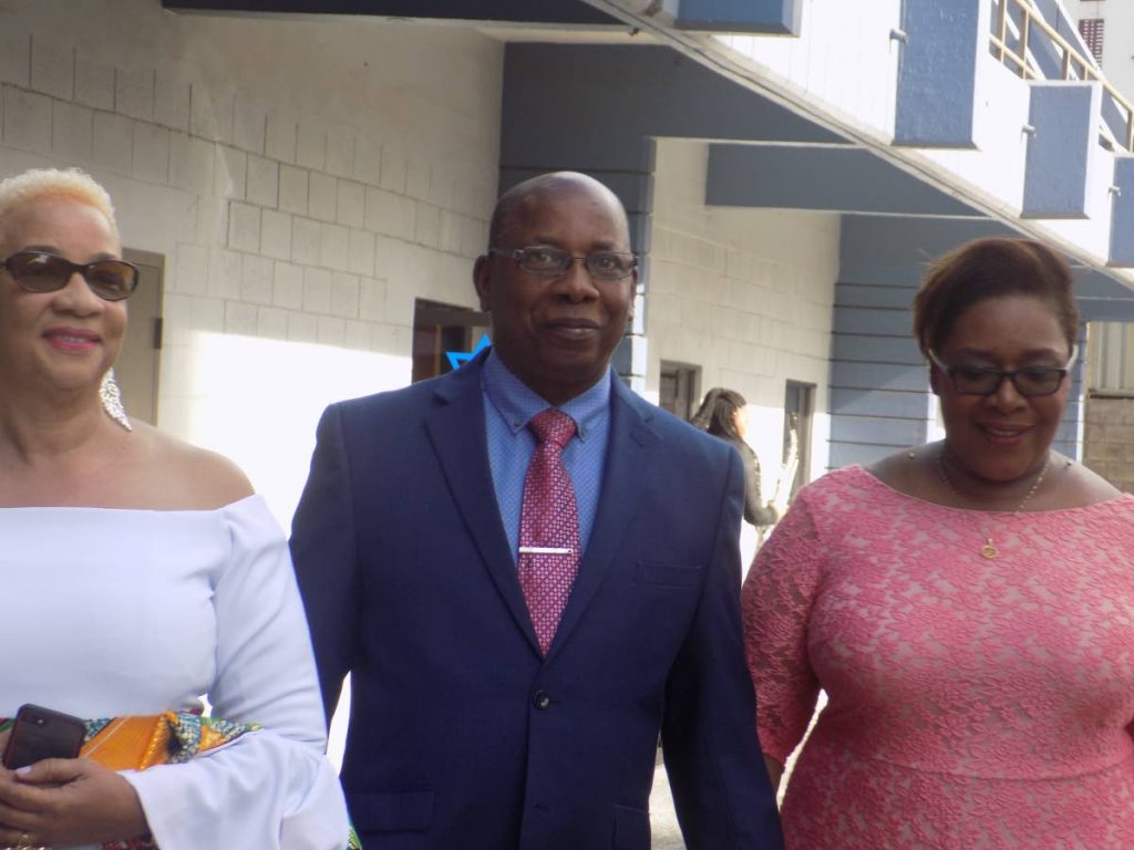FIX YOUNG PEOPLE: Former acting police commissioner Stephen Williams, centre walks alongside his wife Avason Quinlan-Williams, right and secretary general of the police service retiree’s association Julie Carrington outside Riverside Plaza in Port of Spain Sunday.