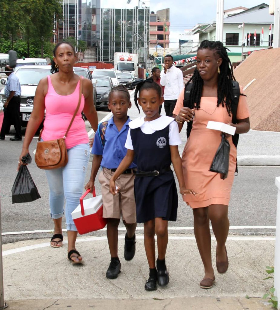 Parents of pupils of Tranquillity Government Primary School in Port of Spain take their kids home earyly after a  disruption in their pipe borne water supply, that this is due to a ruptured WASA 36-inch diameter transmission main, along the Beetham Highway, which occurred on Sunday.PHOTO SUREASH CHOLAI  