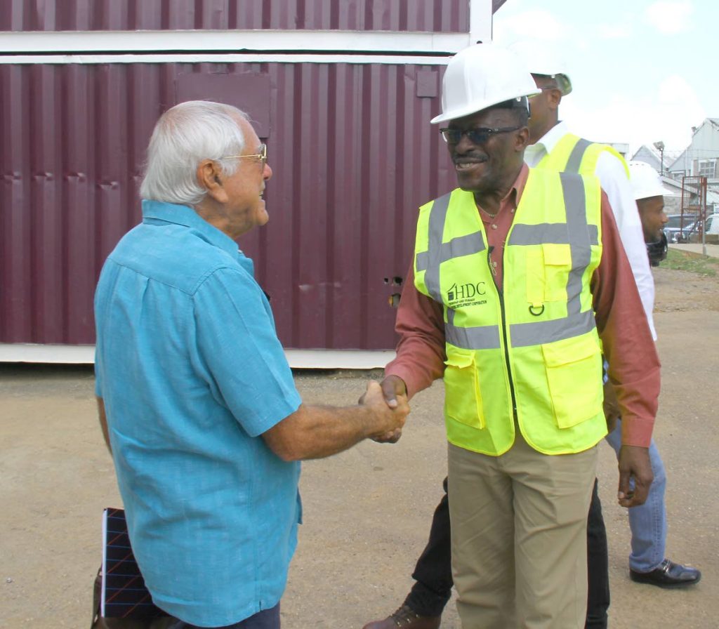 HEY THERE: Housing Minister Edmund Dillon, right, greets NH (International) chairman Emile Elias yesterday during a tour of a HDC site which is under construction in Mt Hope. PHOTO BY ROGER JACOB