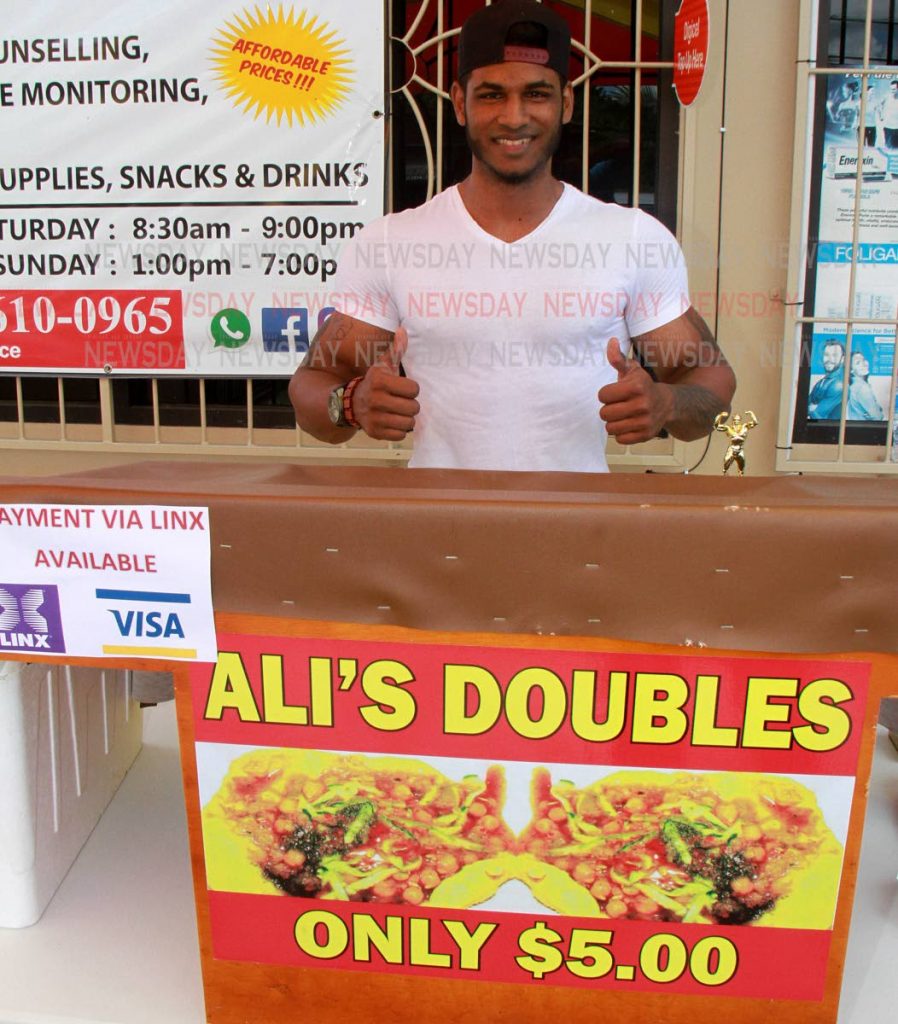 PAY WITH CARD: Doubles man Rasheed Ali of Rio Claro who is offering card payment instead of cash for his doubles.