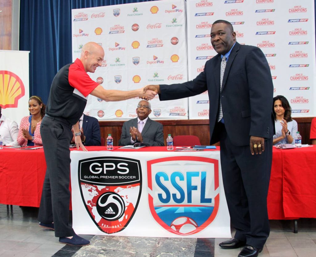 NEW PARTNERS: William Wallace, right, president of the Secondary Schools Football League, shakes the hand of Global Premier Soccer CEO Joe Bradley at the launch of this year’s league at Fatima College in Mucurapo, yesterday. Education Minister Anthony Garcia, middle, applauds the partnership as Sports Max’s Tanya Lee and Shell’s Kellie-Marie Patel look on.