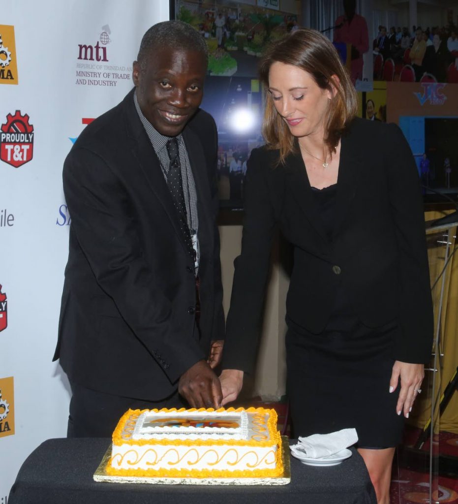 Permanent secretary in the Trade and Industry Ministry Norris Herbert and first vice president of the TT Manufacturers Association Franka Costelloe cut a cake to mark the anniversary of the Trade and Industry Convention at the launch of TIC 2019. Photo by Vashti Singh