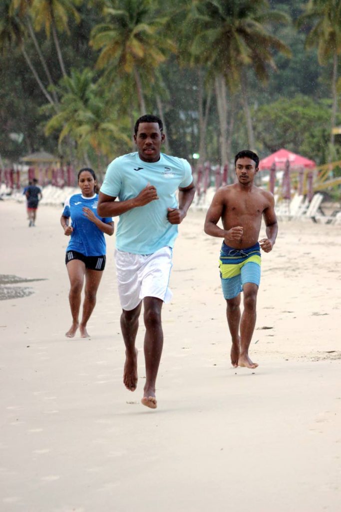 Torpedoes Swim Team members (from left) Virsnelit Faure, Xavier Razac and Alex Ali run along the Maracas Bay shore as they prepare for the ASATT Subway Maracas Open Classic, which takes place on Sunday. PHOTO COURTEYS TORPEDOES SWIM TEAM  