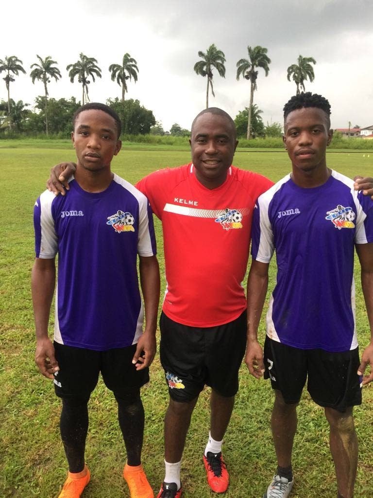 Club Sando head coach Angus Eve, centre, poses with recent signings Jabarry Francis, left, and Jabari Mitchell.