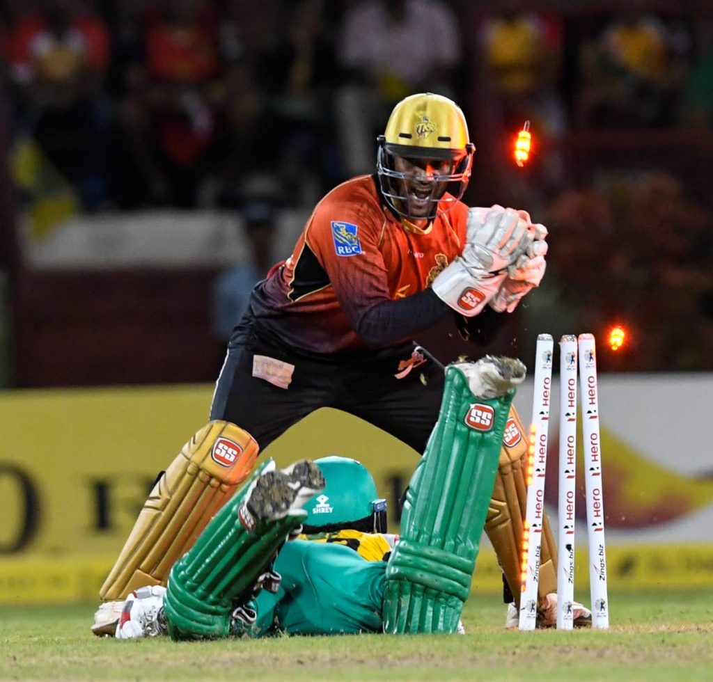 Chadwick Walton of Guyana Amazon Warriors is run out by Trinbago Knight Riders wicketkeeper Denesh Ramdin during the Hero Caribbean Premier League playoff on Tuesday at Guyana National Stadium in Providence, Guyana. PHOTO BY RANDY BROOKS - CPL T20  