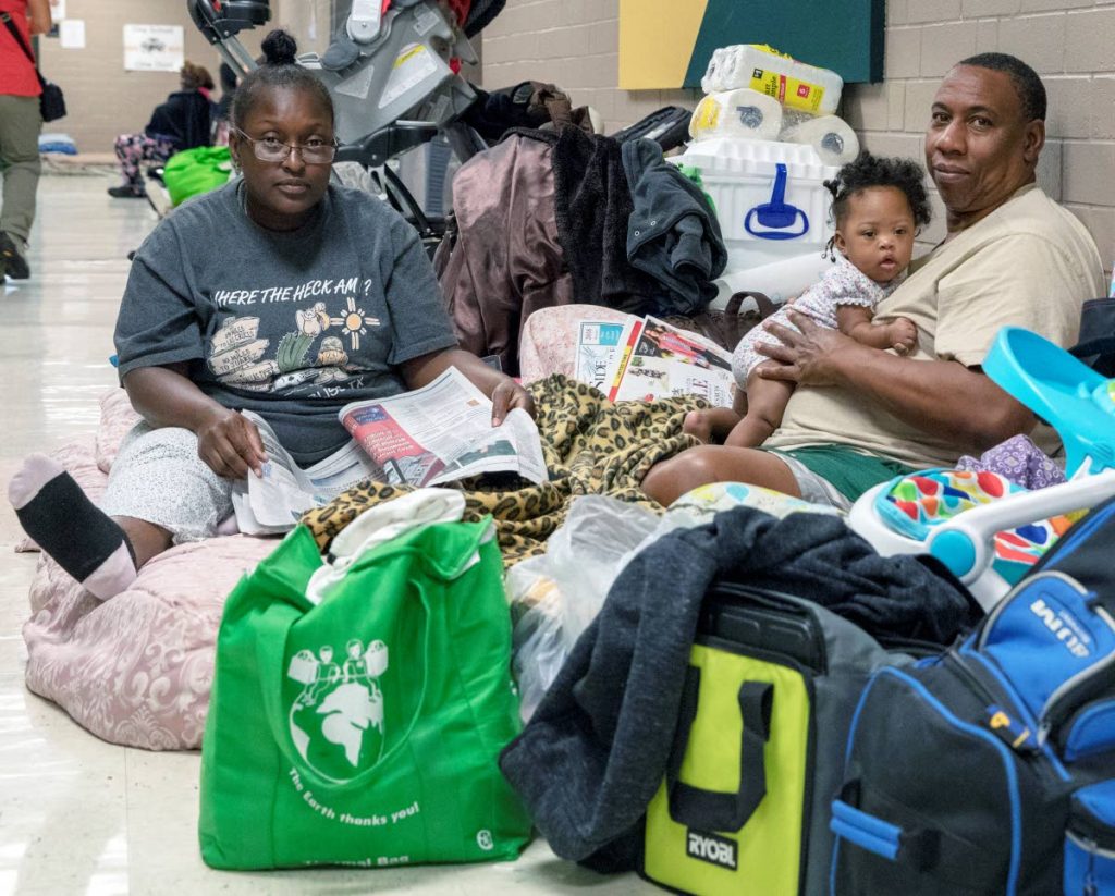 Avair Vereen, her fiance and one of her seven children at a shelter in Conway, South Carolina yesterday as several states along the US eastern coast were bracing for the arrival of Hurricane Florence.