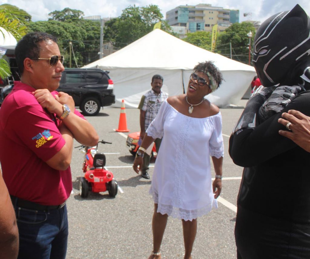 Police Commissioner gives the Wakanda forever sign to Black Panther, a portrayal of the superhero by police officer Christian Felician, during the Police Men Can Cook competition, Queen's Park Savannah, Port of Spain yesterday. PHOTO BY ENRIQUE ASSOON
