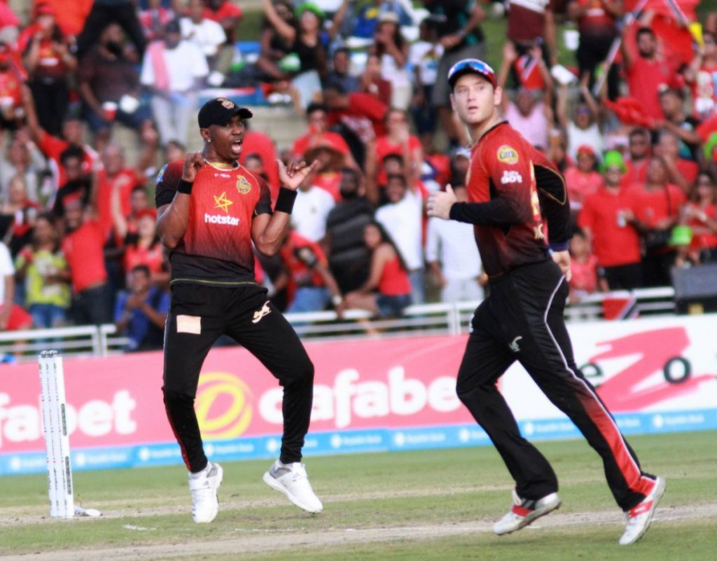 DANCING DJ: Trinbago Knight Riders captain Dwayne Bravo, left, celebrates a wicket in the Hero Caribbean Premier League final at the Brian Lara Academy in Tarouba, Sunday.