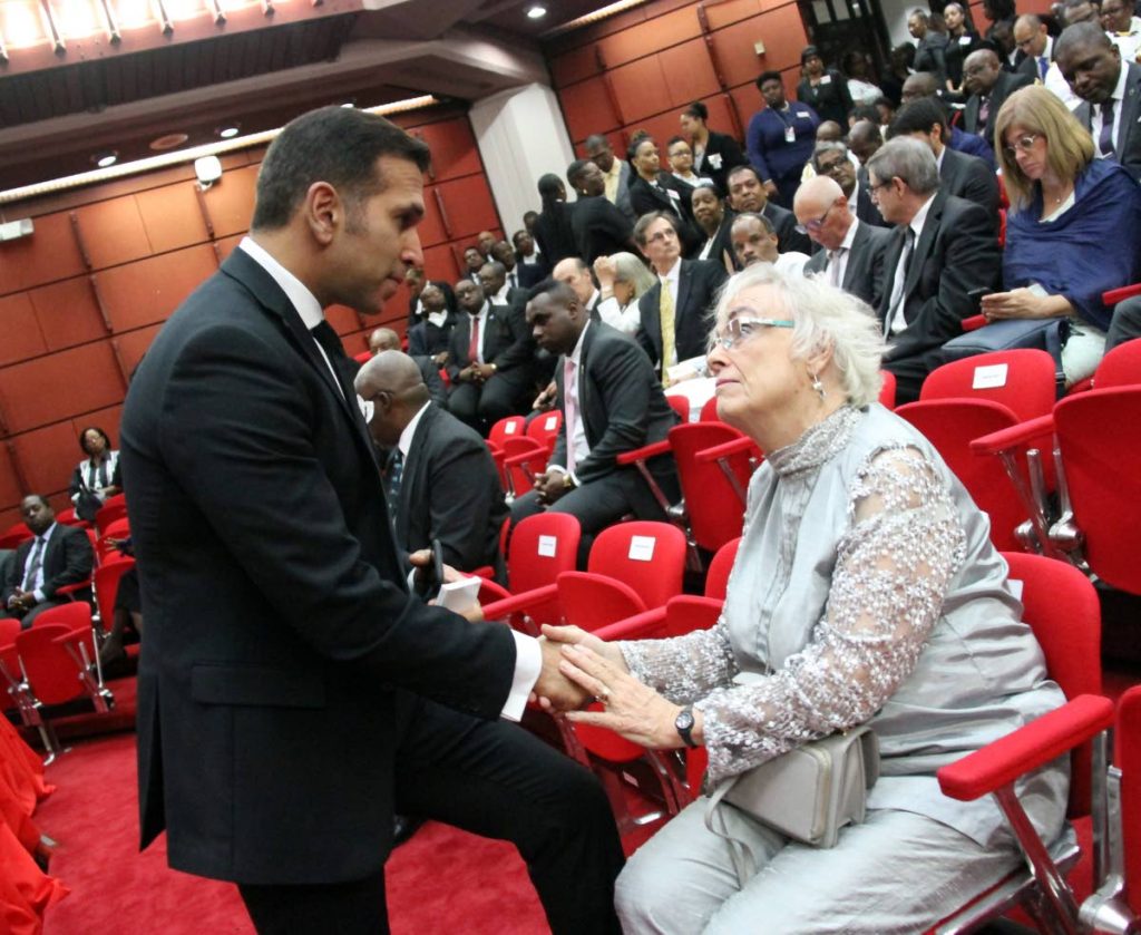 Attorney General Faris Al-Rawi greets activist Diana Mahabir-Wyatt yesterday at the ceremonial opening of the 2018/2019 law term at the Hall of Justice.