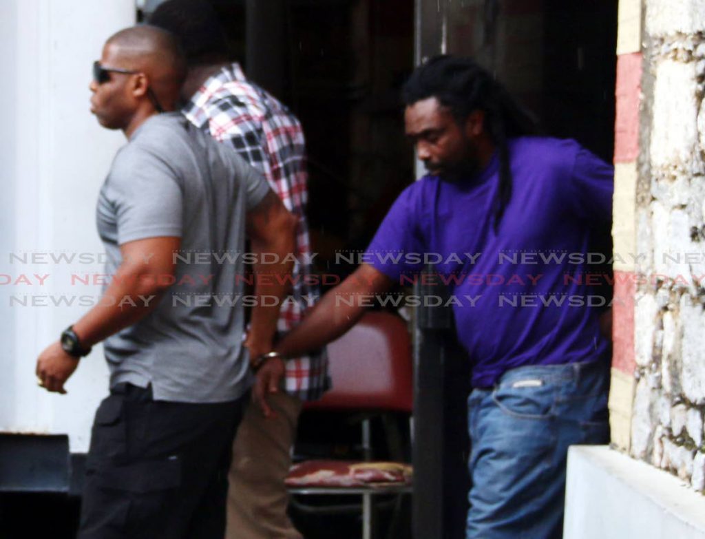 File photo: Gregory James (right) is escorted by PC George to the San Fernando High Court today to appear for the kidnapping of Natalie Pollonais PHOTO BY: ANSEL JEBODH 