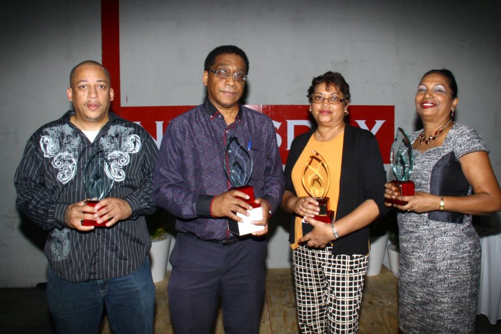 STALWARTS: Newsday employees (from left) Andre Sandy, Horace Monsegue, Gail Balwant-Khan and Shirley Roban after receiving their 25 years of service awards at a Long Service Awards Ceremony held at Newsday's headquarters in El Socorro. Missing is Manoj Christopher who also received his award at the event. 
PHOTOS BY ROGER JACOB