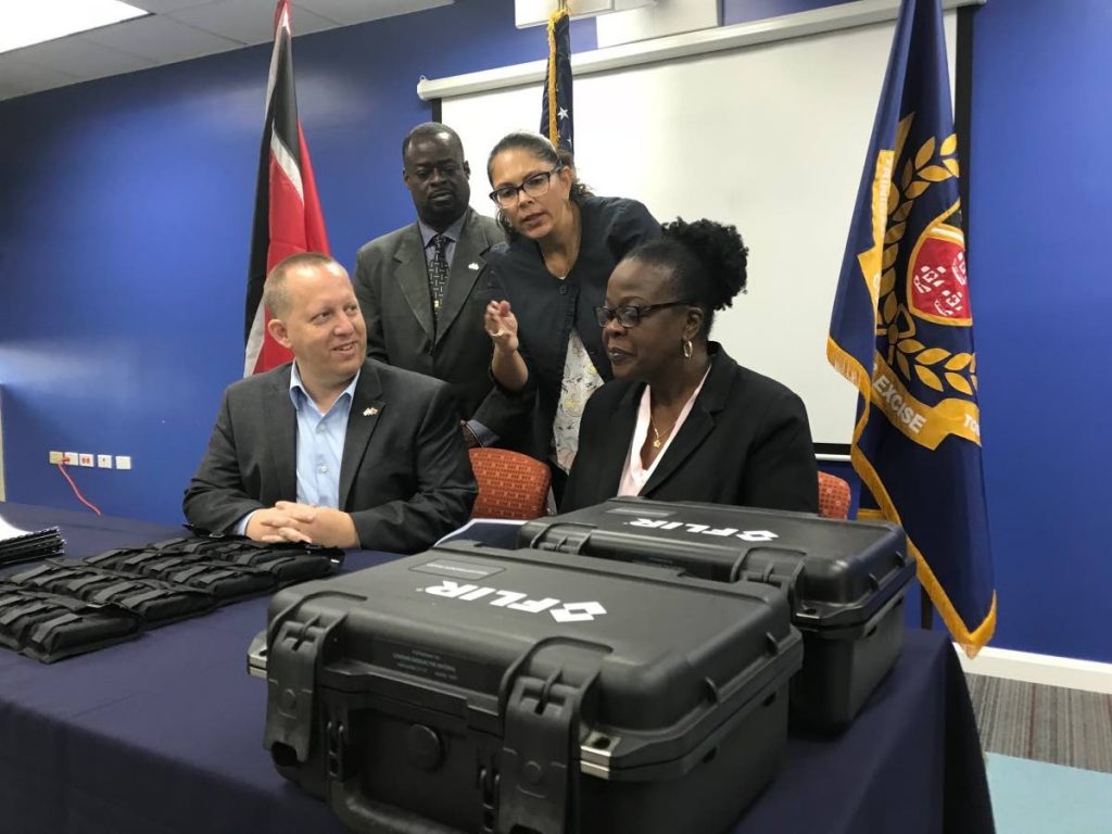 CHECK IT OUT: Department of State Export Control and Border Security Advisor Monica Dorado (second from right) makes a point during a presentation of radiation detection equipment by the US government to local Customs. Looking is (from left) Chargé d’Affaires John W McIntyre, Department of Homeland Security representative Arthlyn Samuel and Acting Comptroller of Customs and Excise Kathy-Ann Matthews.