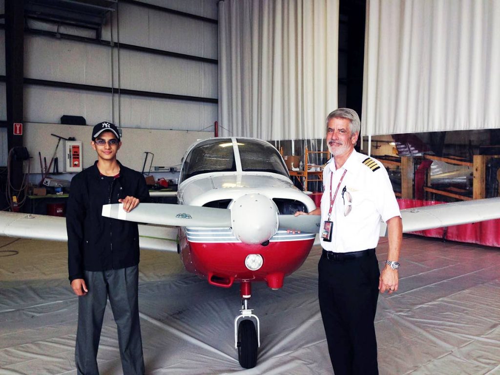 CHARGED: Trini-born aviation student Nishal Sankat is seen at left in this photo posted to his FB account, with an instructor at the Florida Institude of Technology. Sankat has been charged with attempting to steal an AA airbus.