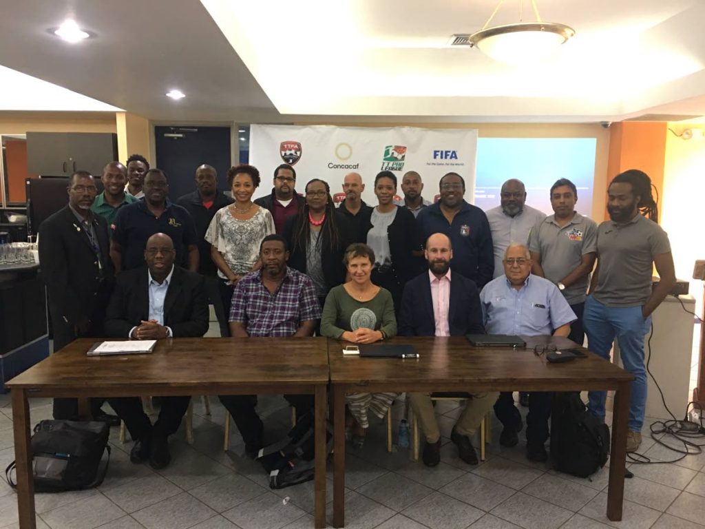 FULL SUPPORT: (Seated, left to right) Howard McIntosh, ONE CONCACAF and Caribbean Projects senior manager, TT Football Association president David John-Williams, Eva Pasquier, head of international relations at UEFA, UEFA ASSIST’s Kenny MacLeod and TT Pro League chairman Richard Fakoory, are joined by other TT football stakeholders at the end of a three-day UEFA ASSIST workshop, Road to Strategic Planning for the Pro League, at the Faculty of Social Sciences of the University of the West Indies, St. Augustine Campus, Thursday.