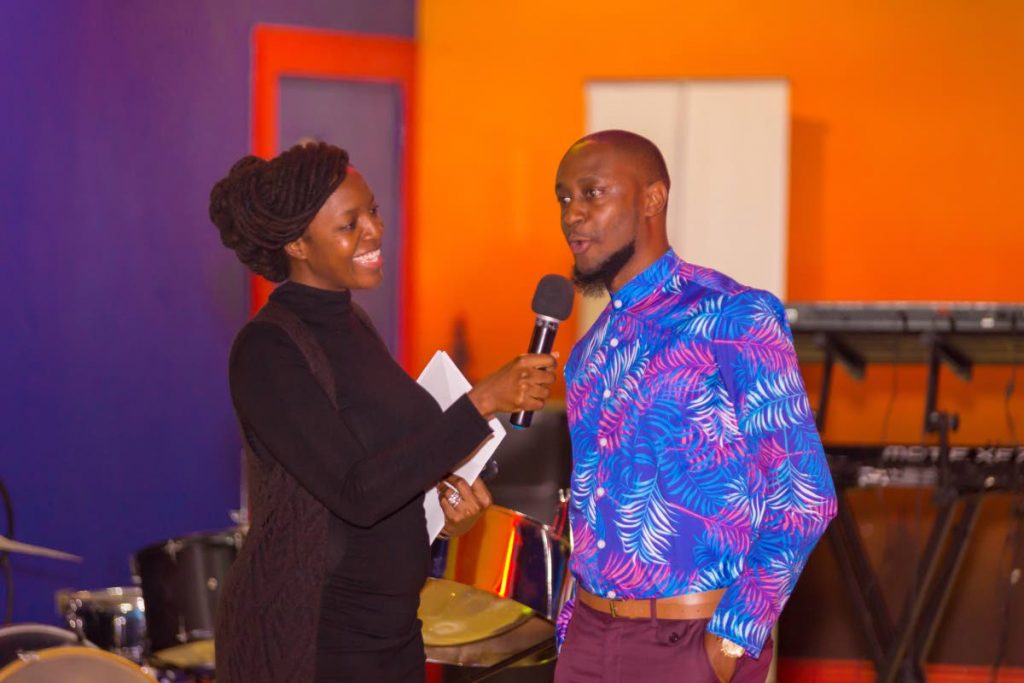 Spoken Word artiste Kleon McPherson is interviewed by Natalie Johnson at the premiere of his Back in Times video production, which he entered in the TT Film Festival, at Movie Towne, Gulf City mall, Lowlands last Saturday. Photos by David Reid