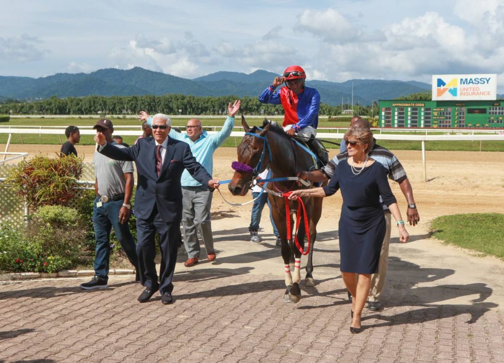 The connections of 'Cape Canaveral' lead the 2018 Carib Brewery Trinidad Derby winner, with jockey Ricardo Jadoo aboard, into the winners circle, at the Santa Rosa Park, Arima yesterday. 