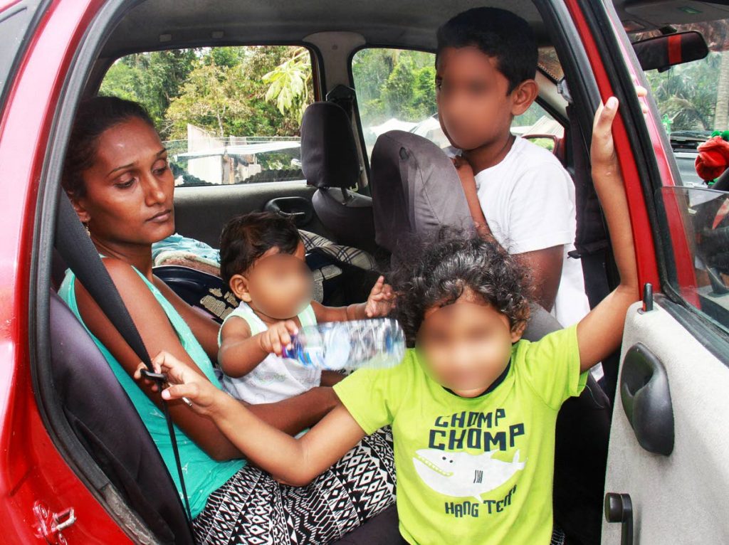 HELP US: Priya Mohamed with her three children, whose faces have been digitally blurred as they are minors, who were also left homeless after the fire. 