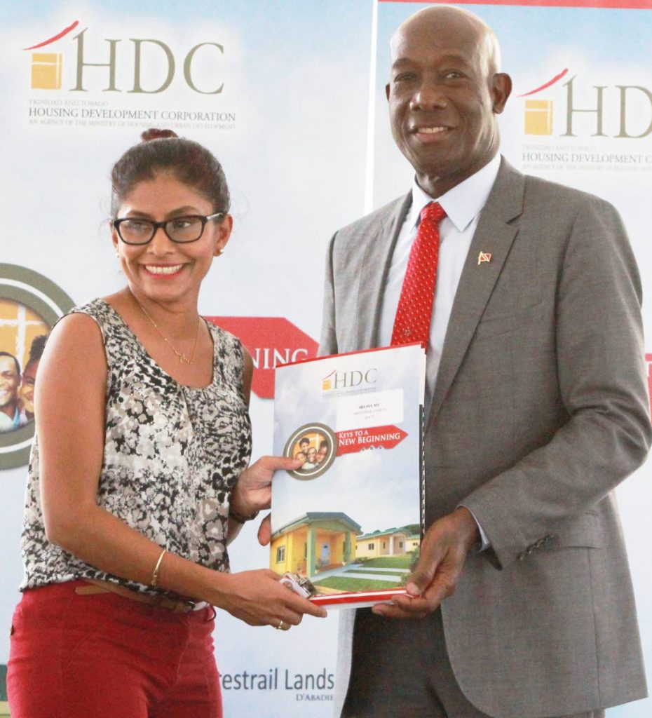 Melisa Ali is all smiles as she receives the keys to her new HDC home during a key distribution ceremony yesterday in D’Abadie.